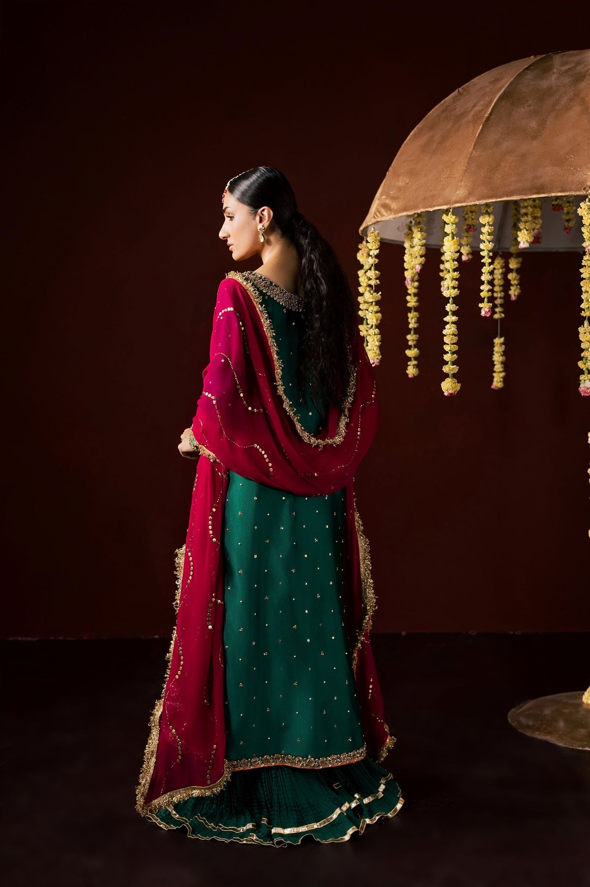 Zonaira Ahmed Haya emerald green maroon wedding formal 3-piece – full-length back view beside umbrella prop