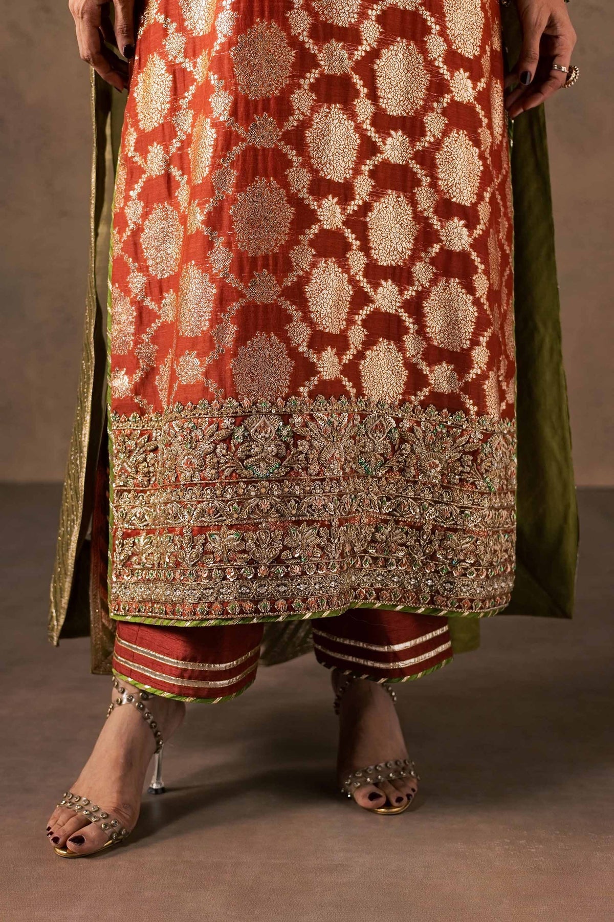 Zonaira Ahmed Mehr rust gold wedding formal 3-piece – close-up of the hem embroidery, striped pajama, and jeweled heels