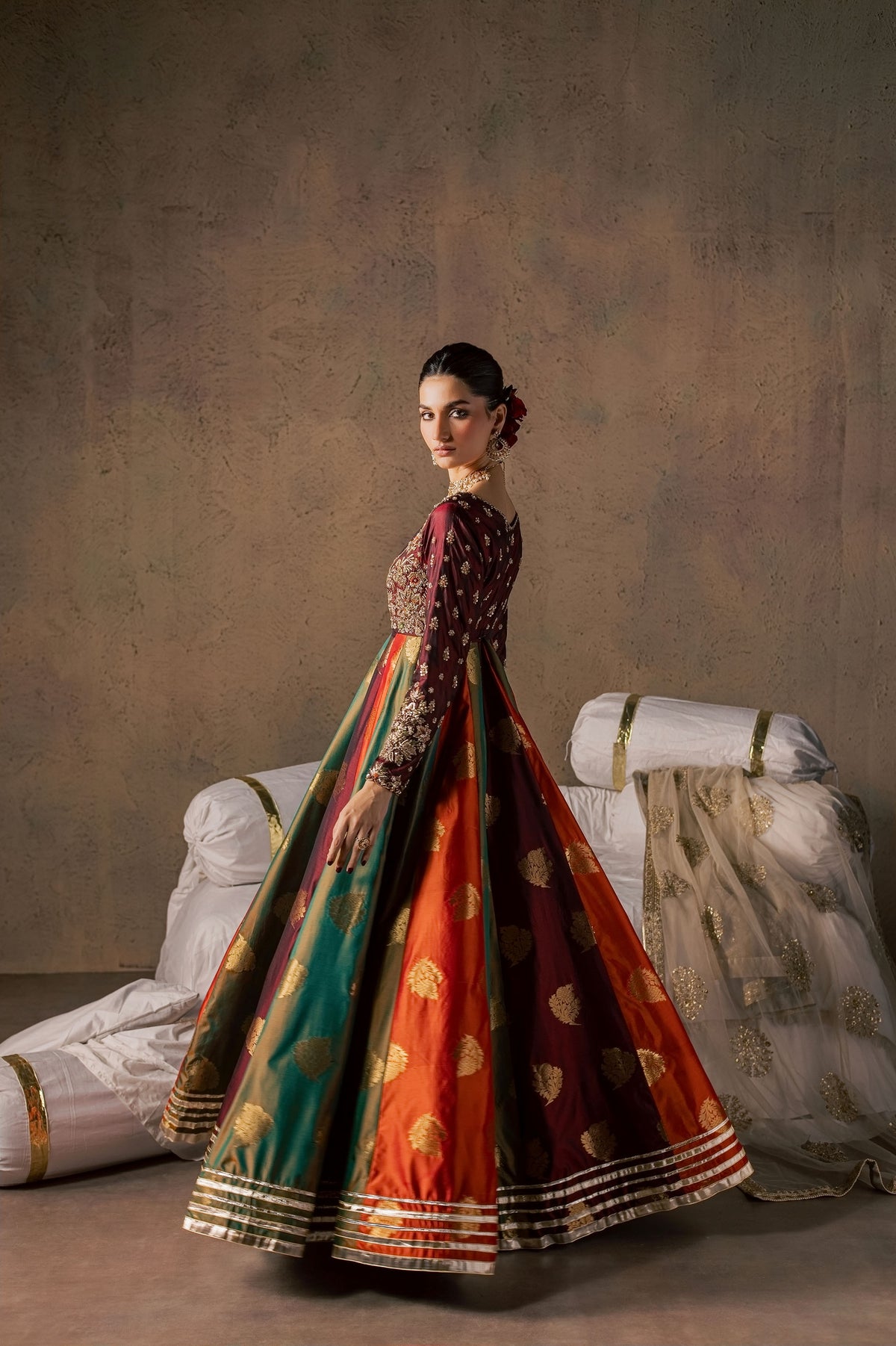 Zonaira Ahmed Naurang maroon multicolor wedding formal 3-piece – twirling back three-quarter view looking over the shoulder