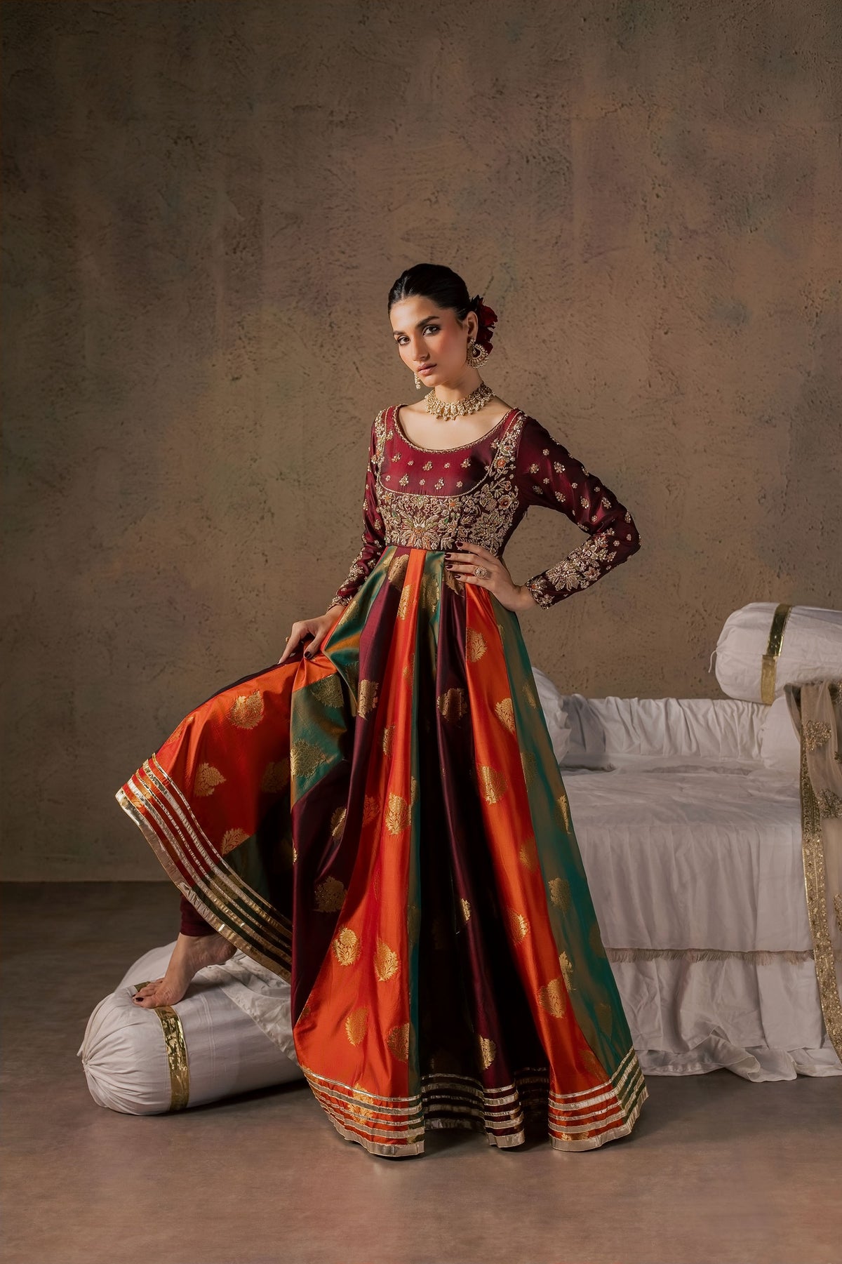 Zonaira Ahmed Naurang maroon multicolor wedding formal 3-piece – hand-on-hip pose with the skirt lifted showing the lining