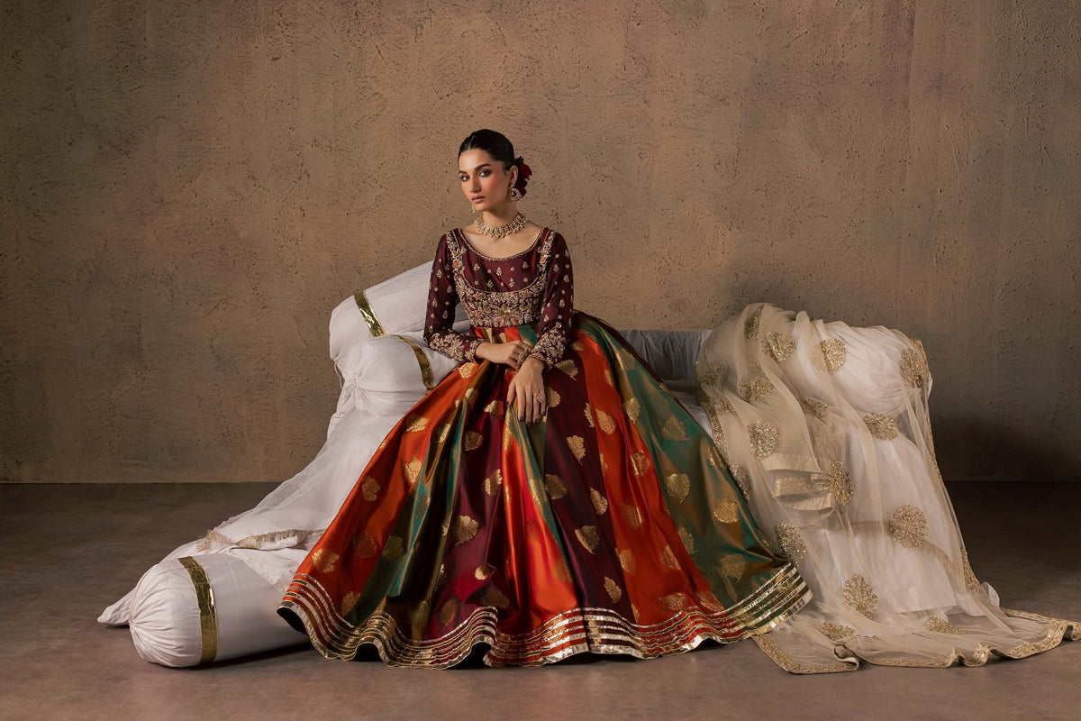 Zonaira Ahmed Naurang maroon multicolor wedding formal 3-piece – reclined lifestyle shot on a draped daybed