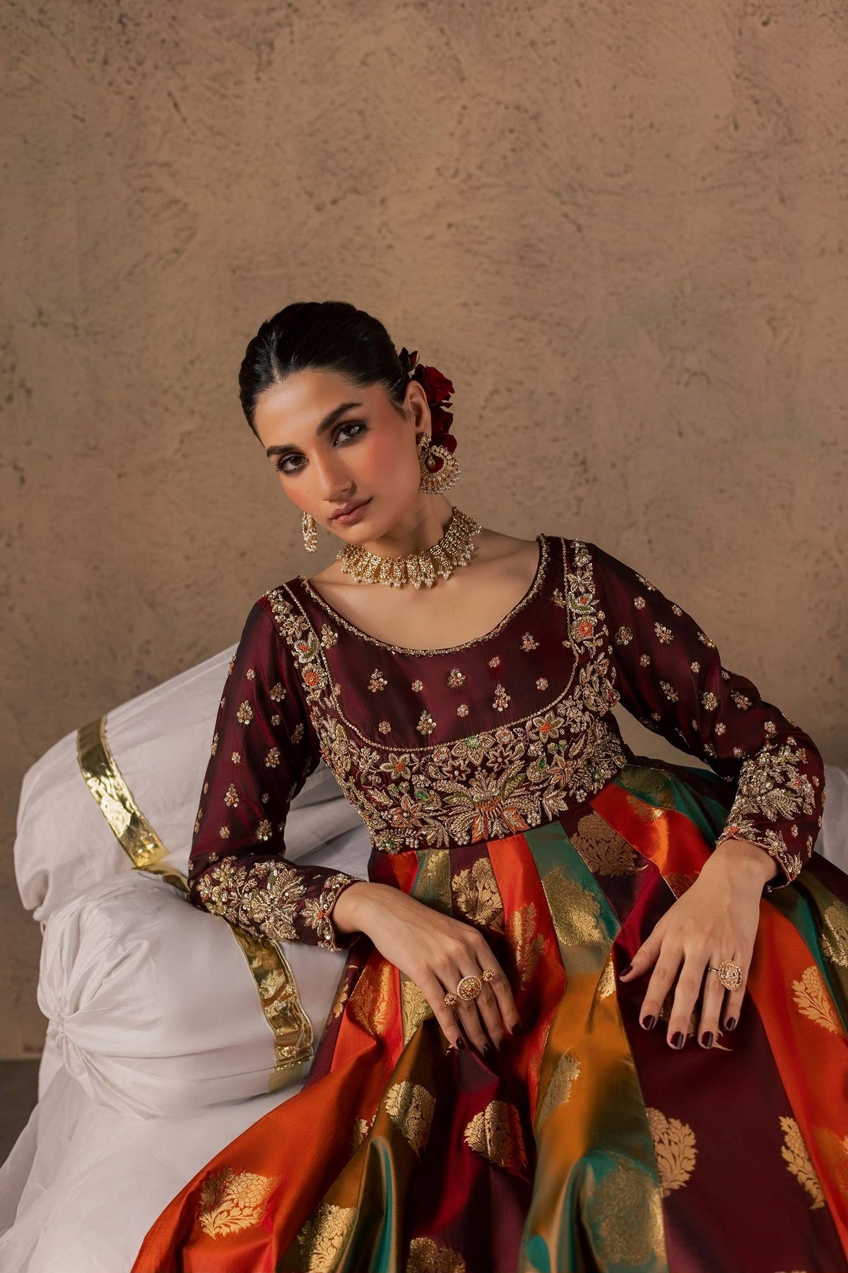 Zonaira Ahmed Naurang maroon multicolor wedding formal 3-piece – close-up reclined portrait resting hand on cushion