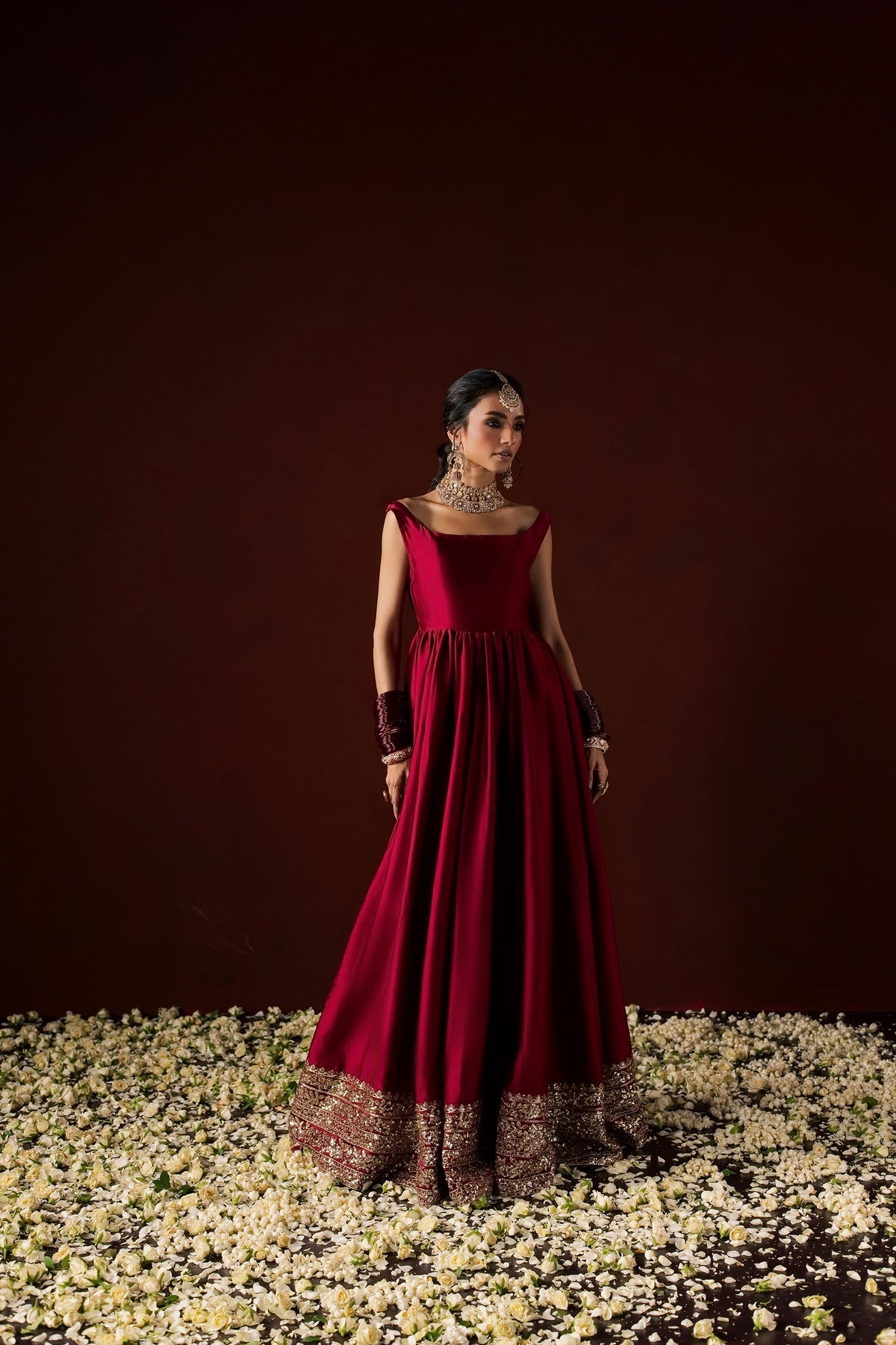 Zonaira Ahmed Neysa maroon wedding formal peshwas – front view without dupatta, showing the flowing gown silhouette and gold embellished hem