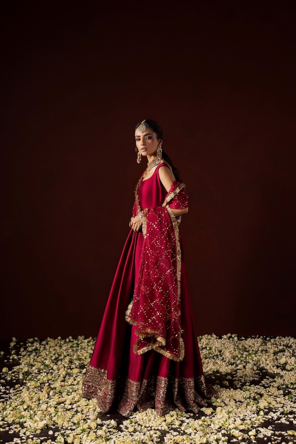 Zonaira Ahmed Neysa maroon wedding formal peshwas – full-length front turn showing the flowing silhouette and gold embellished hem border