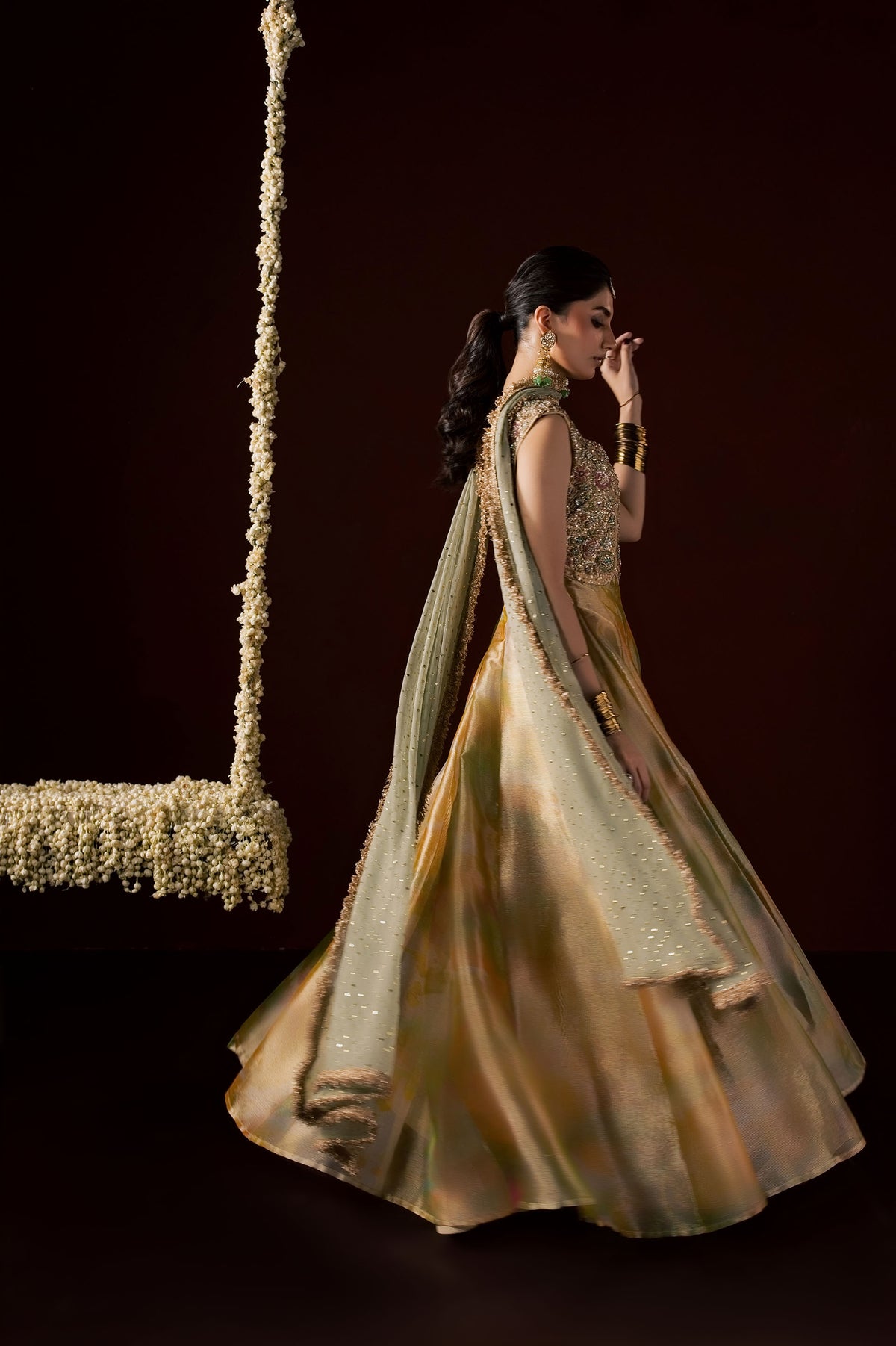Zonaira Ahmed Nooré gold ombre wedding formal 3-piece – side profile walking, hand near chin, skirt swirling in motion