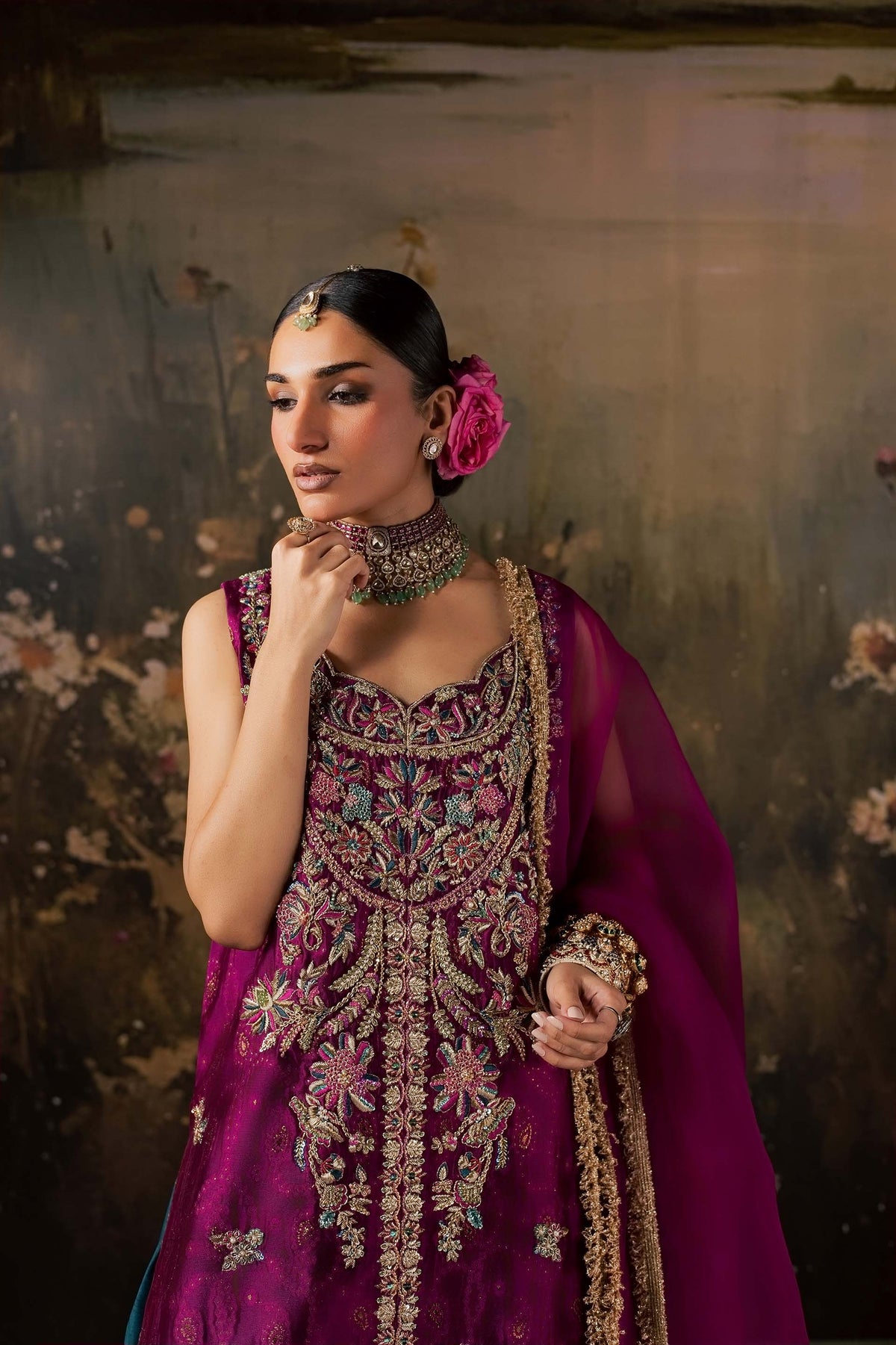 Zonaira Ahmed Rania magenta teal wedding formal 3-piece – portrait with hand near chin, choker and embroidery detail visible, painted lake backdrop