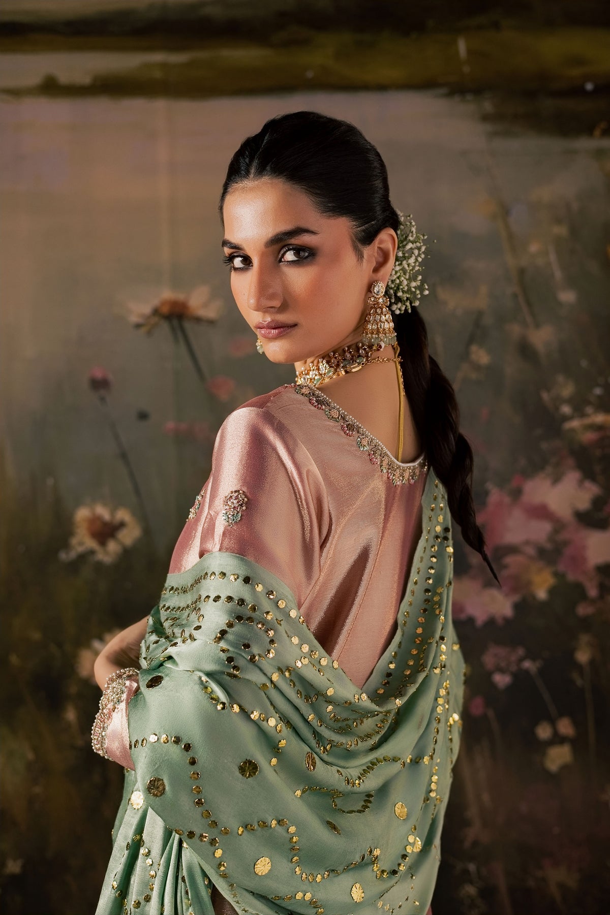 Zonaira Ahmed Reem dusty rose sage wedding formal 3-piece – side profile with dupatta draped over shoulder, sequin embellishment detail, floral backdrop