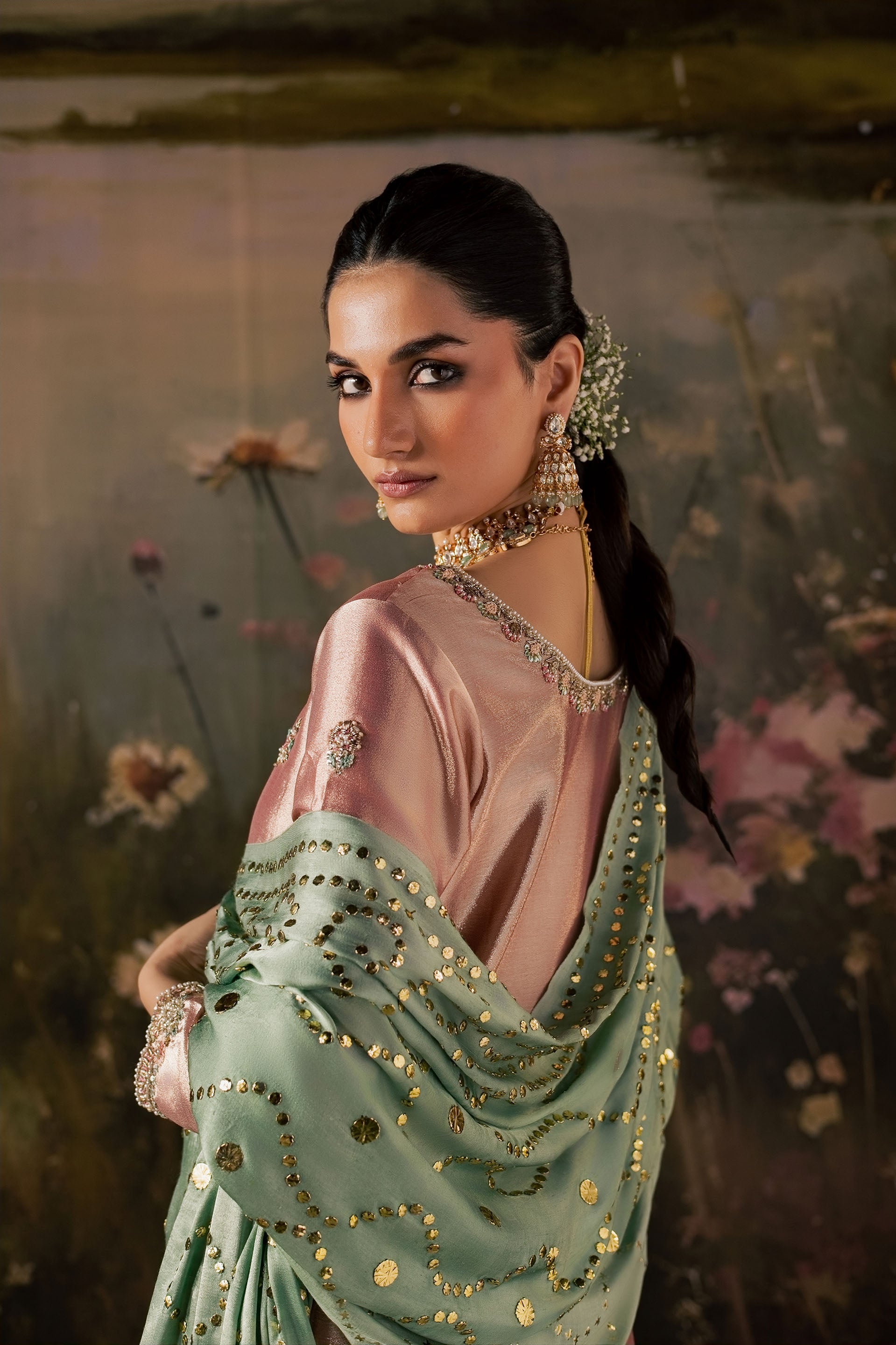 Zonaira Ahmed Reem dusty rose sage wedding formal 3-piece – side profile with dupatta draped over shoulder, sequin embellishment detail, floral backdrop