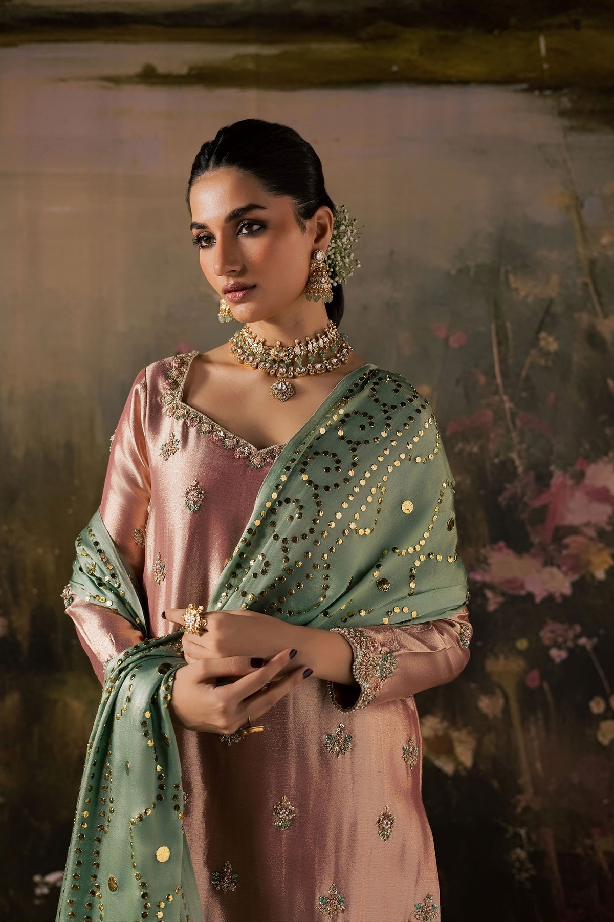 Zonaira Ahmed Reem dusty rose sage wedding formal 3-piece – front view with neckline embroidery detail, hands clasped, painted lake backdrop