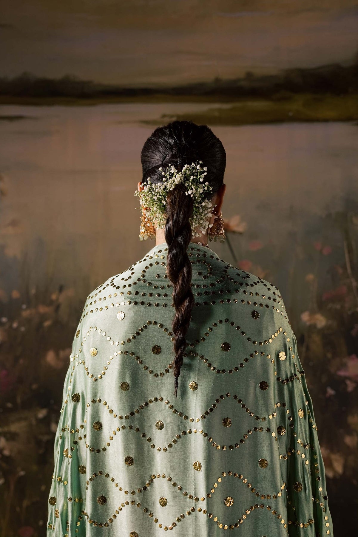 Zonaira Ahmed Reem dusty rose sage wedding formal 3-piece – back view of sage-green sequinned dupatta with mirror-work pattern, hair braided with flowers, lake backdrop