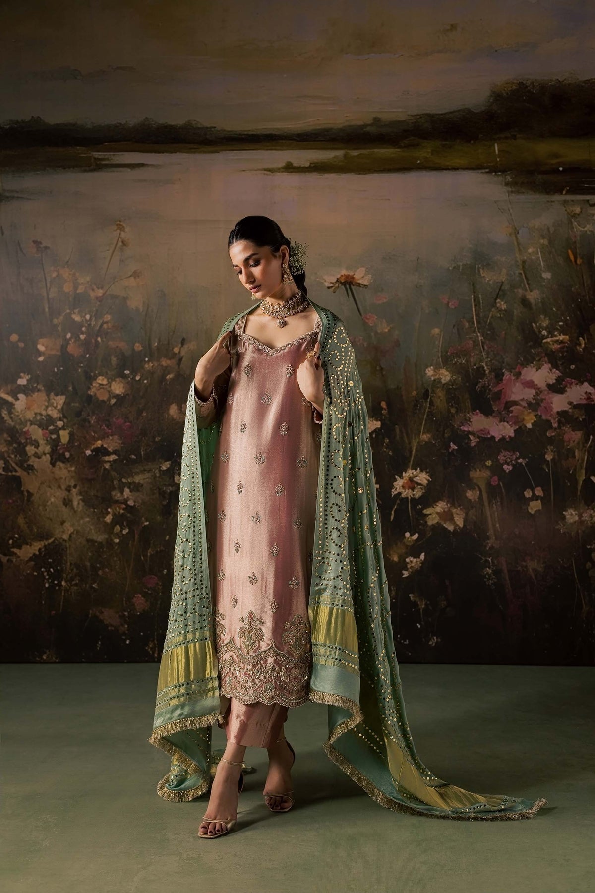 Zonaira Ahmed Reem dusty rose sage wedding formal 3-piece – full-length side view with dupatta spread open showing mirror-work sequin pattern and striped border, floral lake backdrop