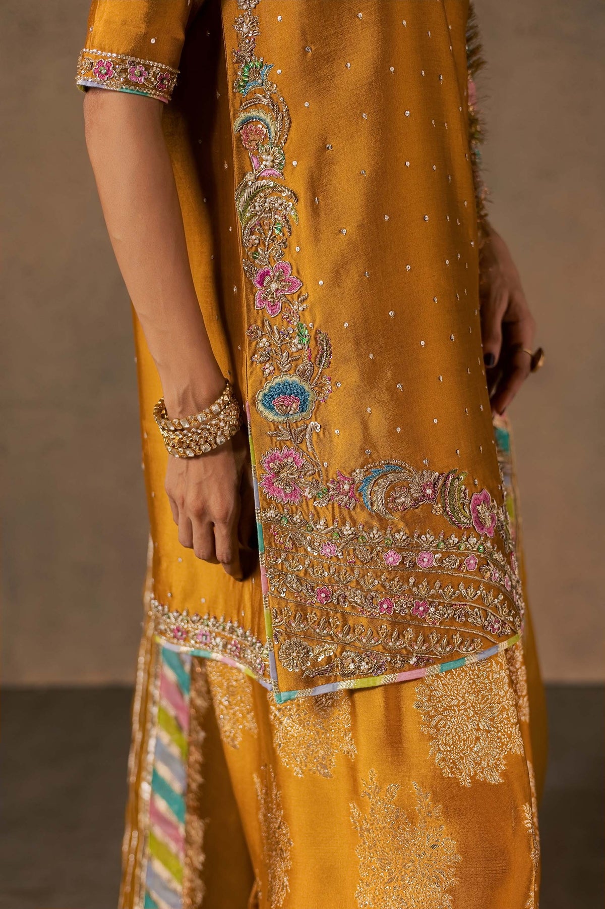 Zonaira Ahmed Zarmin mustard wedding formal 3-piece – close-up of front placket floral embroidery with matching bracelet